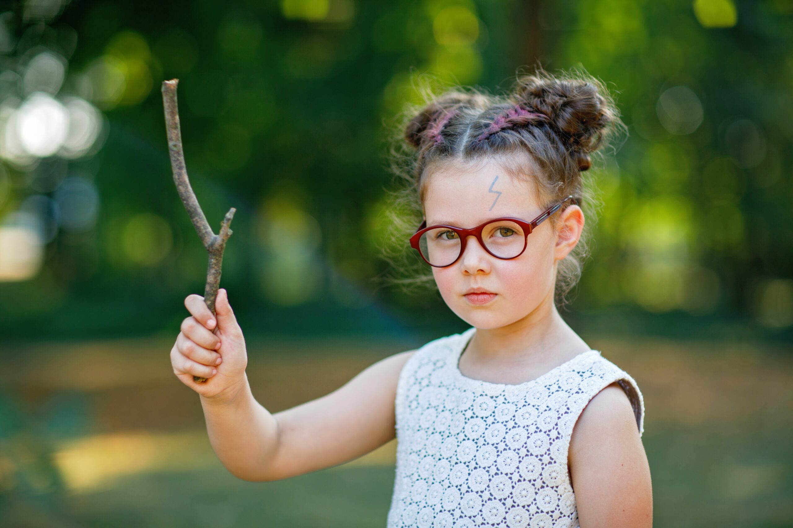funny,adorable,little,kid,girl,with,glasses,and,wooden,magic